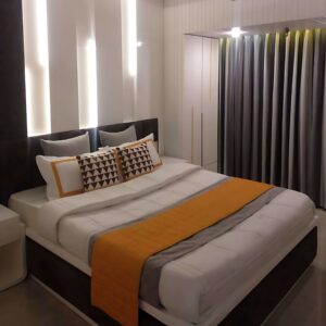 Bedroom interior design. White and grey theme with little orange.